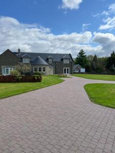 a brick driveway in front of a house at Rohallian in Stanley