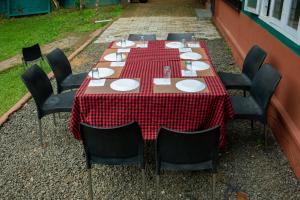 a table with a red and white checkered table cloth at The Nest Thattekad in Thattakād