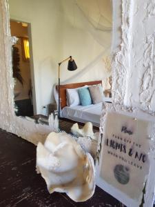 a hotel room with a bed and a shell on the floor at Tropical Bungalows-Siargao in General Luna