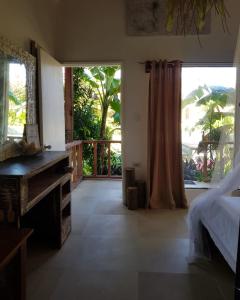 a bedroom with a bed and a large window at Prana Siargao Resort in General Luna
