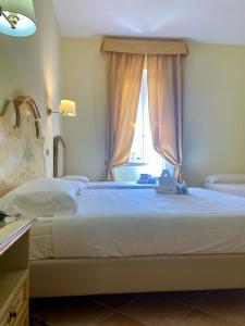 a bedroom with a large bed with a window at Sourire Hotel in Rome