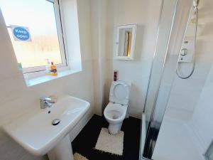 a bathroom with a sink and a toilet and a shower at 3 Guest Rooms in a 3bed house with kitchen, ENSUITE options also available in Telford
