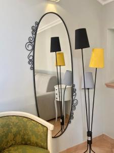 a mirror in a room with a couch and lamps at Sourire Hotel in Rome