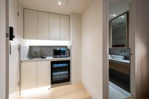 a kitchen with a sink and a microwave at Paragon in Sydney