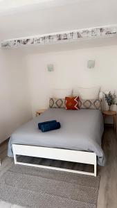 a bedroom with a white bed with a white headboard at La lavande in Arles