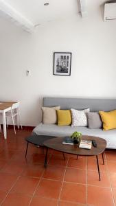 a living room with a couch and a table at La lavande in Arles