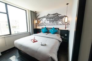 Letto o letti in una camera di Gong Xili Qingdu Hotel