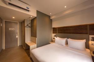 a bedroom with a large bed with white pillows at Stanley Wahid Hasyim Jakarta in Jakarta
