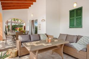 a living room with a couch and a table at Menorca Cristina by Mauter Villas in Cala Blanca