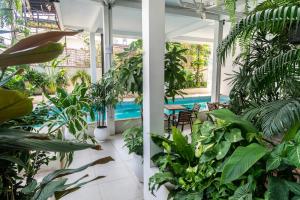 a room filled with lots of plants and a swimming pool at Onederz Siem Reap in Siem Reap