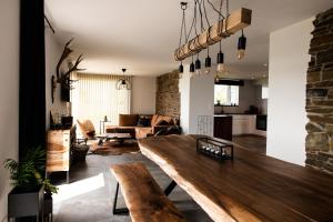 a living room with a wooden table and a couch at Le panorama in Dinant