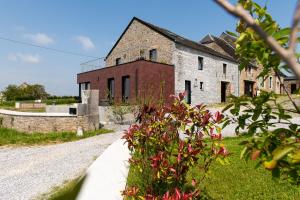an old stone building with a road in front of it at Le panorama in Dinant
