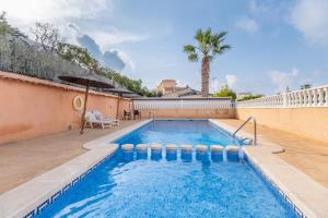 basen z palmą w tle w obiekcie Playa Flamenca Townhouse w mieście Orihuela