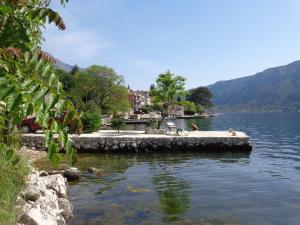 a lake with a dock in the middle of it at Apartments Ponta in Kotor
