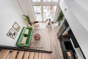 an overhead view of a living room with a green couch at Loft apartment with lake views in Tampere