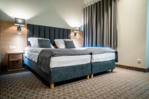 Posteľ alebo postele v izbe v ubytovaní Hotel Turkus