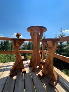 a wooden table on a wooden deck at Almhütte Kärnten in Maltaberg
