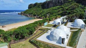 an aerial view of domes on a beach at glampark resort Akuna beach in Henza