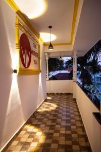 a hallway of a restaurant with a checkered floor at The Woodside Inn in Benaulim