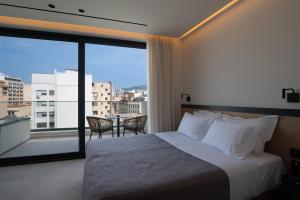 Postel nebo postele na pokoji v ubytování Nema Hotel Athens
