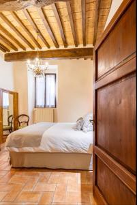 ein Schlafzimmer mit einem Bett und einer großen Holztür in der Unterkunft PienzaLettings "Casa Olivieri" in Pienza
