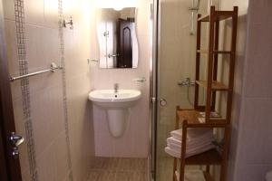 a bathroom with a sink and a toilet and a shower at Family Hotel Bellehouse in Chernomorets +117 photos