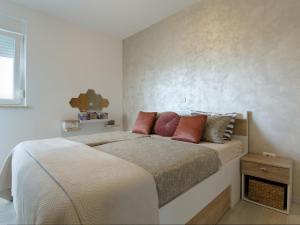 a bedroom with a large bed with red pillows at Apartment Harmony in Umag