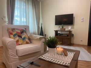a living room with a chair and a coffee table at Apartment in Bansko, very close to the Gondola in Bansko
