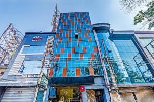 a tall blue building with a lot of windows at Hotel Agoura Prime in Lucknow