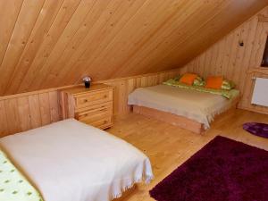 a room with two beds in a wooden cabin at Domek u Bartusia in Wisła