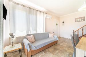 salon z kanapą i oknem w obiekcie Villa Logas w mieście Peroulades