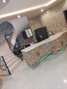 a kitchen with a staircase and a mosaic wall at فيلا لوزان الريف الاوروبي in ‘Ezbet Sharikât Wardan