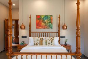 a bed with a wooden frame in a room at Regal Retreat by VEO - Part of StayVista in Wayanad
