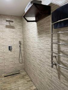 a bathroom with a shower with a glass door at Kolyba Club in Stanishovka