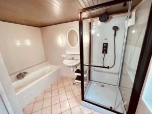 a bathroom with a shower and a sink at Léonie in Walscheid