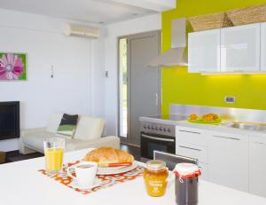 a kitchen with a table with a plate of food on it at Sivota Senses - Villa Loukas in Sivota