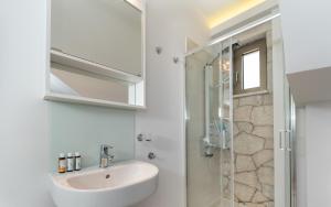 a bathroom with a sink and a shower at Spilia Bay House in Spartokhórion +7 photos