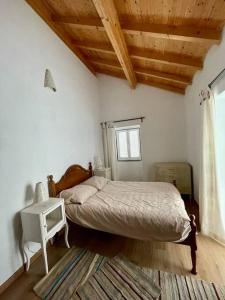 ein Schlafzimmer mit einem Bett und einer Holzdecke in der Unterkunft Casa do Moura in Arcos de Valdevez