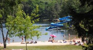 a group of people on the beach at a water park at chez Sabine et Bertrand in Beynat +1 photo