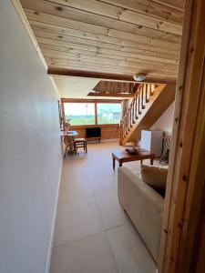 a living room with a staircase and a couch at Nashos Bungalows in (( Spile ))