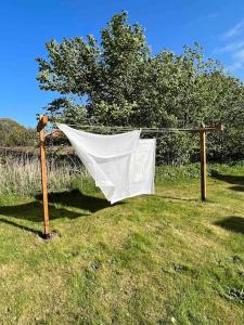 a net on a pole in a field at The Old Soap House - stylish and close to beach in Vang