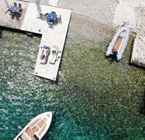 an aerial view of two boats in the water at Symi . VILLA CALME (Sur la Mer). in Symi