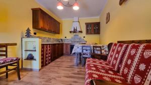 Melarì في Roure Turin: غرفة معيشة مع أريكة ومطبخ