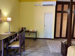 a room with a desk and a chair and a door at Sala Boutique Hotel in Male City