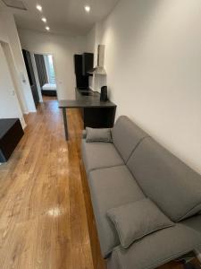 a living room with a couch and a table at Savoia Luxury Apartment in Milan