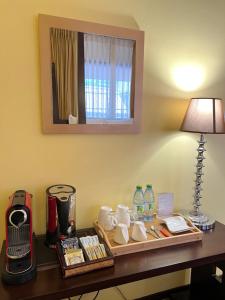 a desk in a hotel room with a table with a lamp at Sala Boutique Hotel in Male City