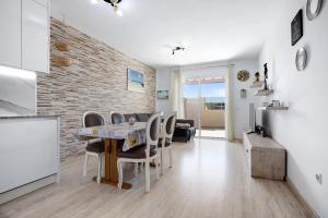 a kitchen and dining room with a table and chairs at Laikas house in Costa Calma