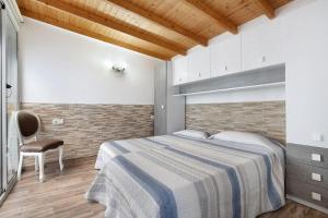 a bedroom with a bed and a chair at Laikas house in Costa Calma