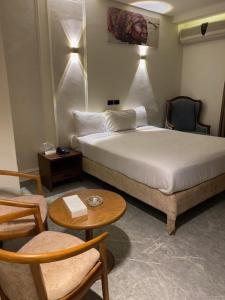 En eller flere senge i et værelse på Green House Hotel