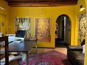 an office with a desk with a computer on a yellow wall at Sala Boutique Hotel in Male City
